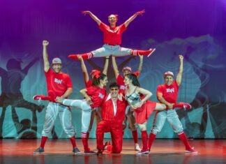 a group of people standing on top of each other on a stage