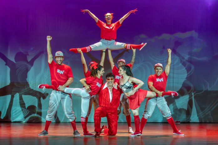 a group of people standing on top of each other on a stage