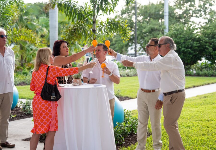 a group of people standing around a table