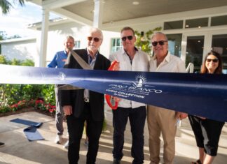 a group of people cutting a ribbon at a ribbon cutting ceremony