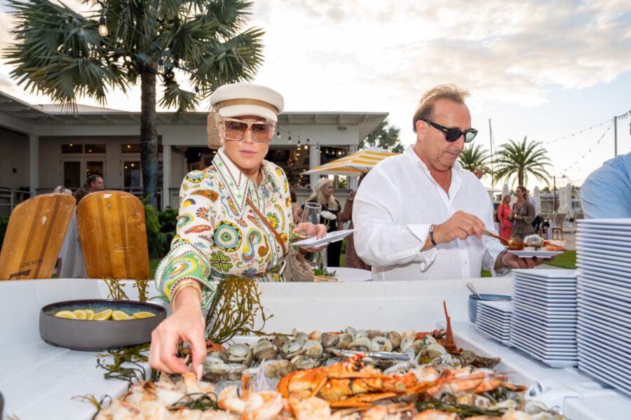 a couple of people that are standing near a table