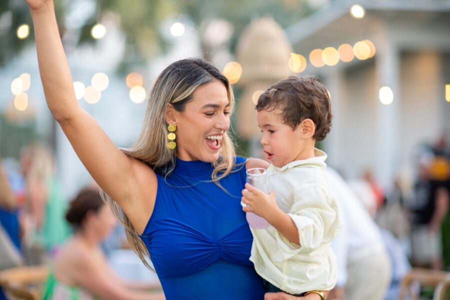 a woman in a blue dress holding a child