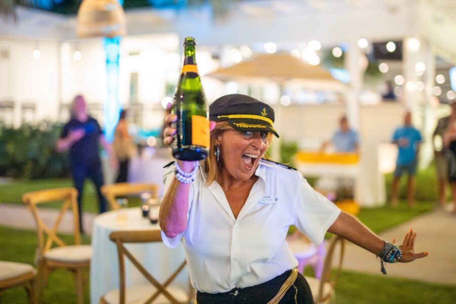 a woman holding a bottle of beer in her hand