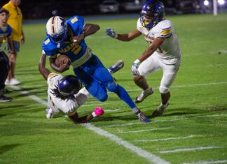 a football player is being tackled by another player