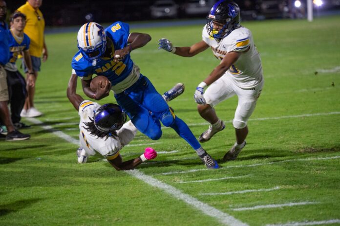 a football player is being tackled by another player