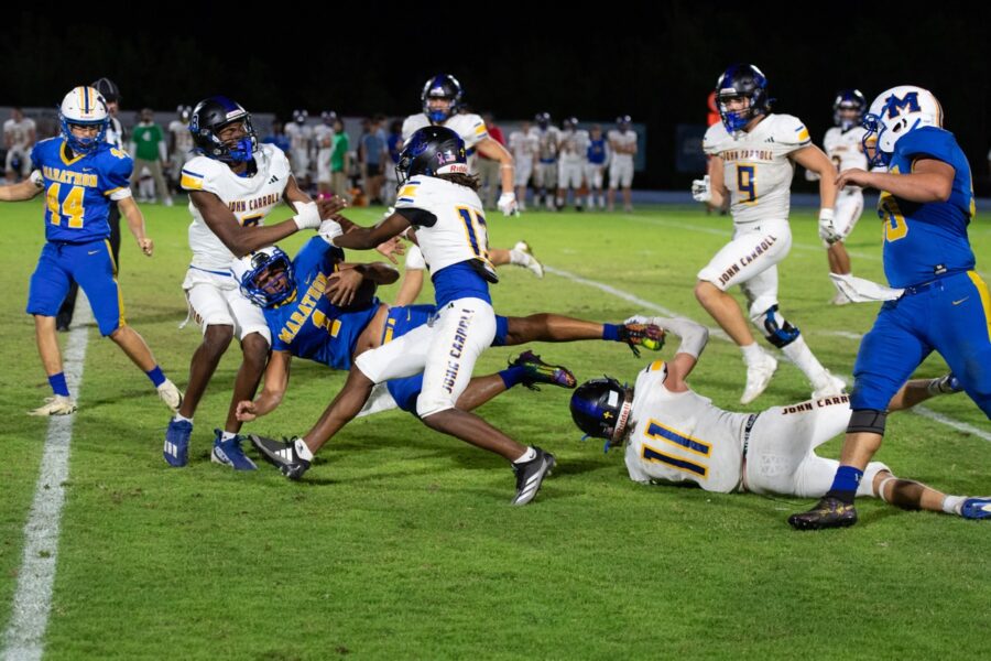 a group of football players playing a game of football