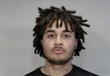 a man with dreadlocks is shown in this mug shot