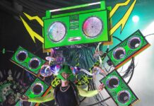 a person standing on a stage with a green box on their head