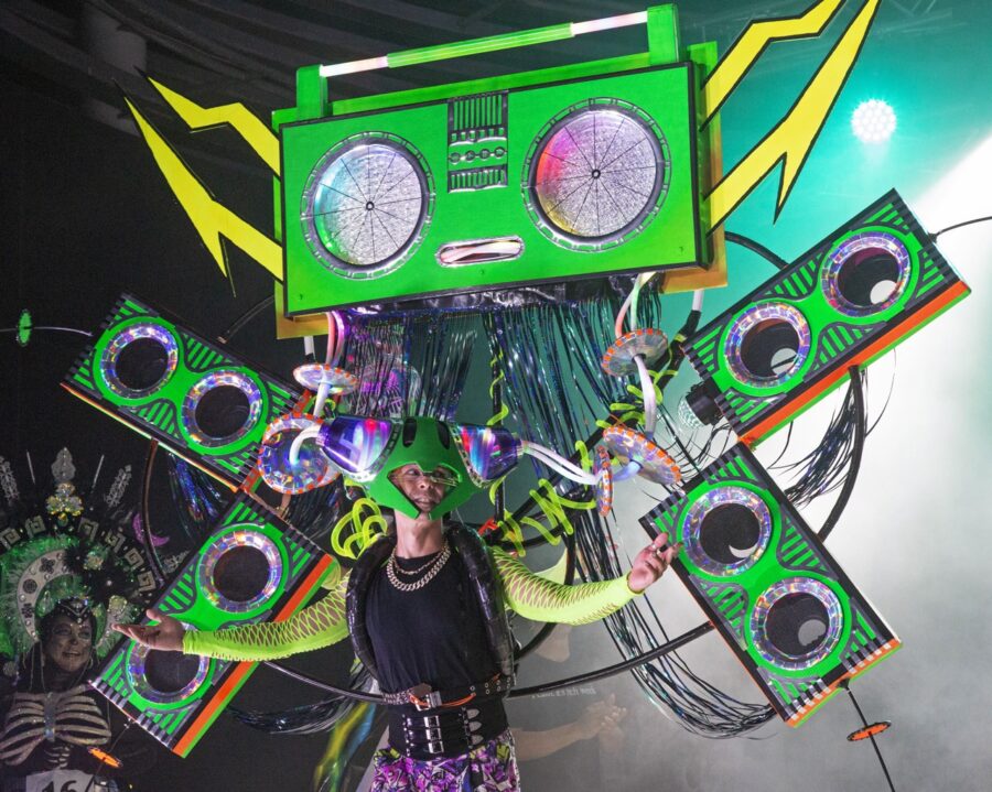 a person standing on a stage with a green box on their head