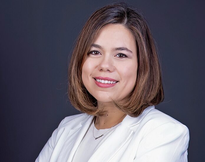 a woman in a white suit smiling at the camera