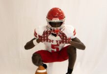 a football player kneeling down with a ball