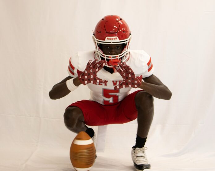 a football player kneeling down with a ball