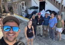 a group of people standing in front of a house