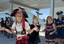 a group of young girls dressed in pirate costumes