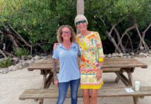 two women standing in front of a picnic table