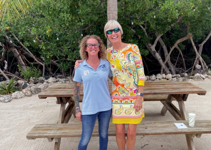 two women standing in front of a picnic table