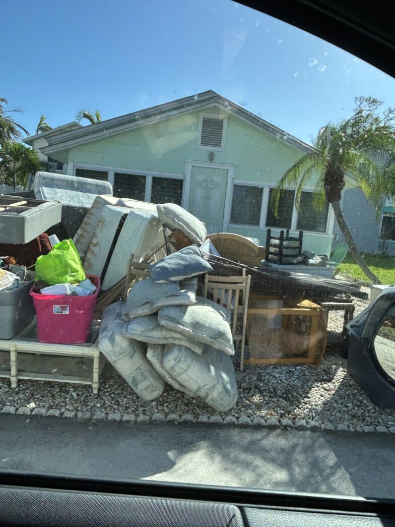 a pile of furniture sitting on the side of a road