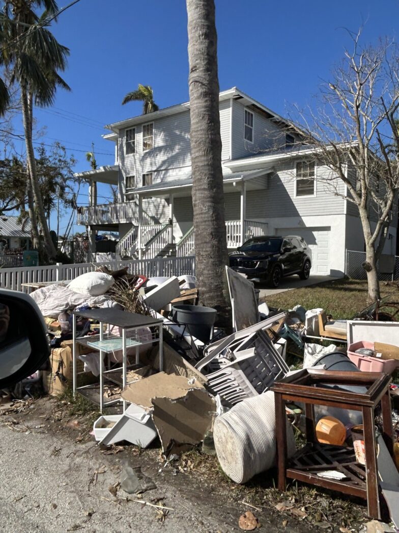 a pile of junk sitting on the side of a road