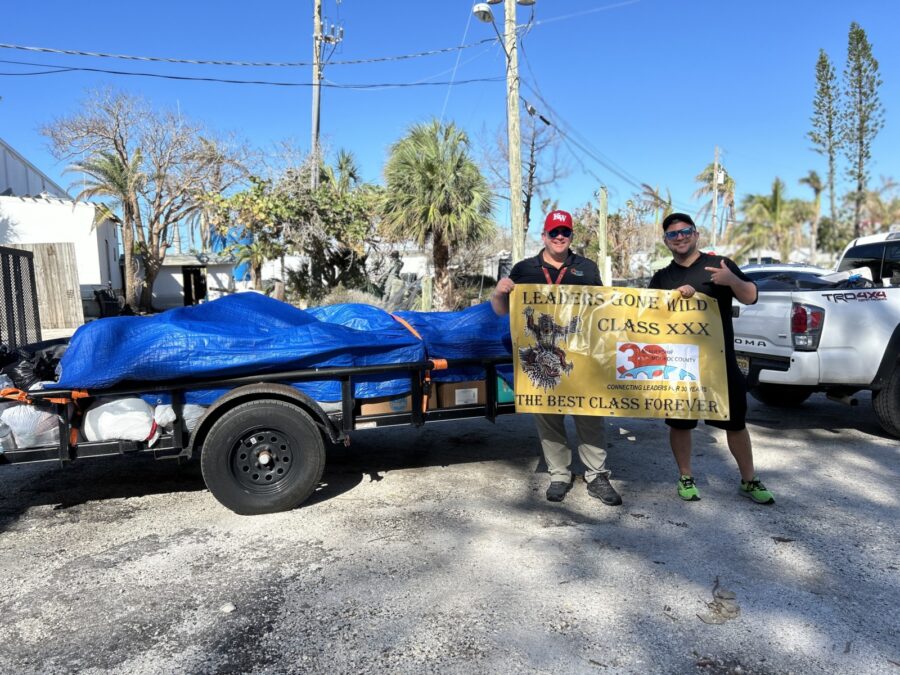 a couple of men standing next to a trailer