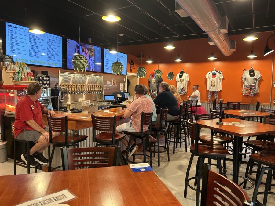 a group of people sitting at tables in a restaurant