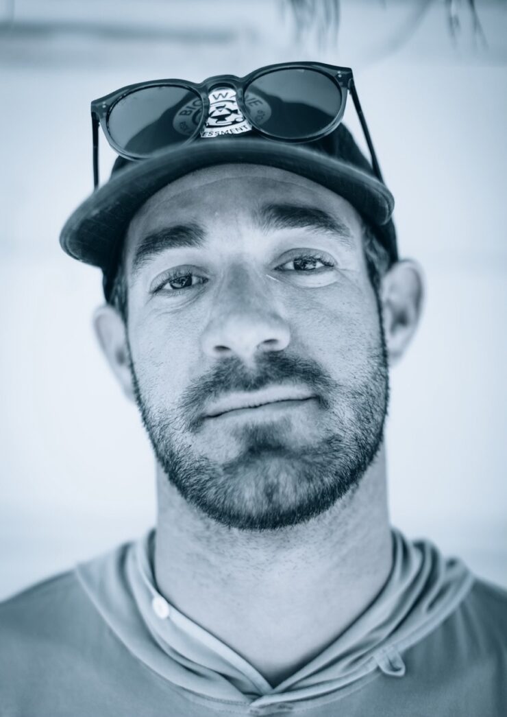 a man wearing a baseball hat and sunglasses