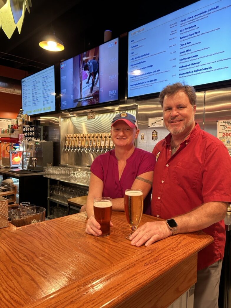 a man and a woman standing at a bar