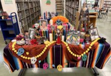 a table covered with books and decorations in a library