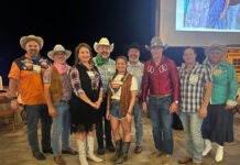 a group of people standing in front of a screen