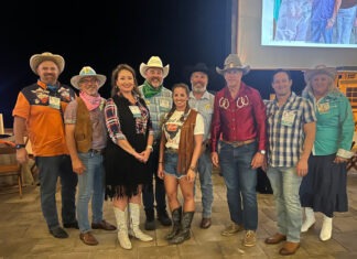 a group of people standing in front of a screen