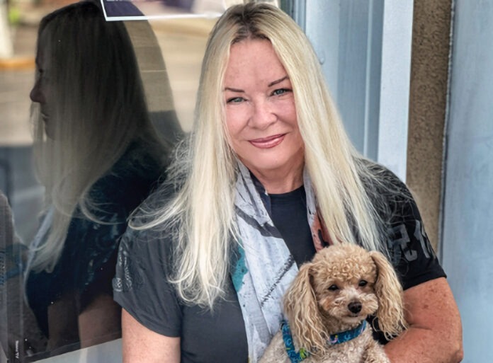 a woman holding a dog in her arms