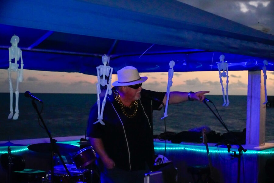 a man standing under a tent next to a drum set