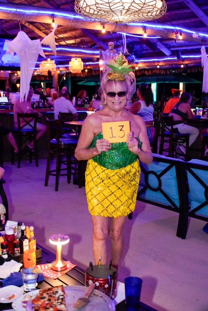 a woman dressed in a pineapple costume at a party