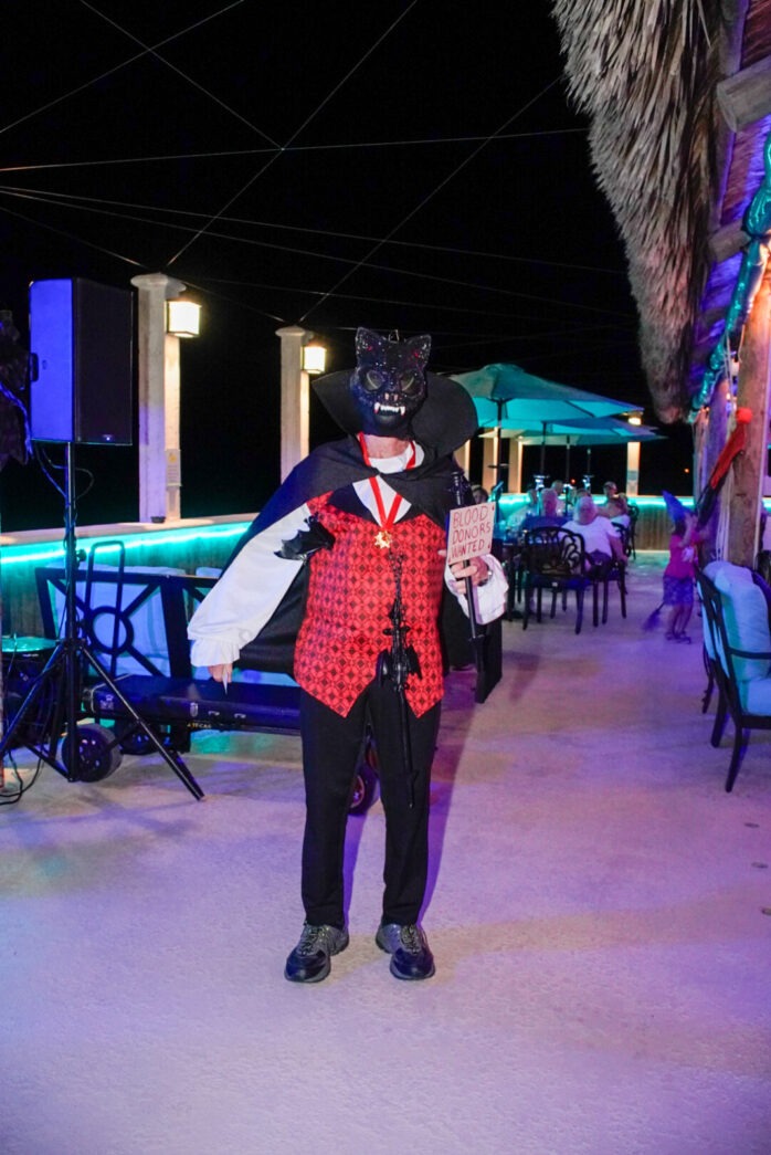 a man in a costume standing in front of a restaurant