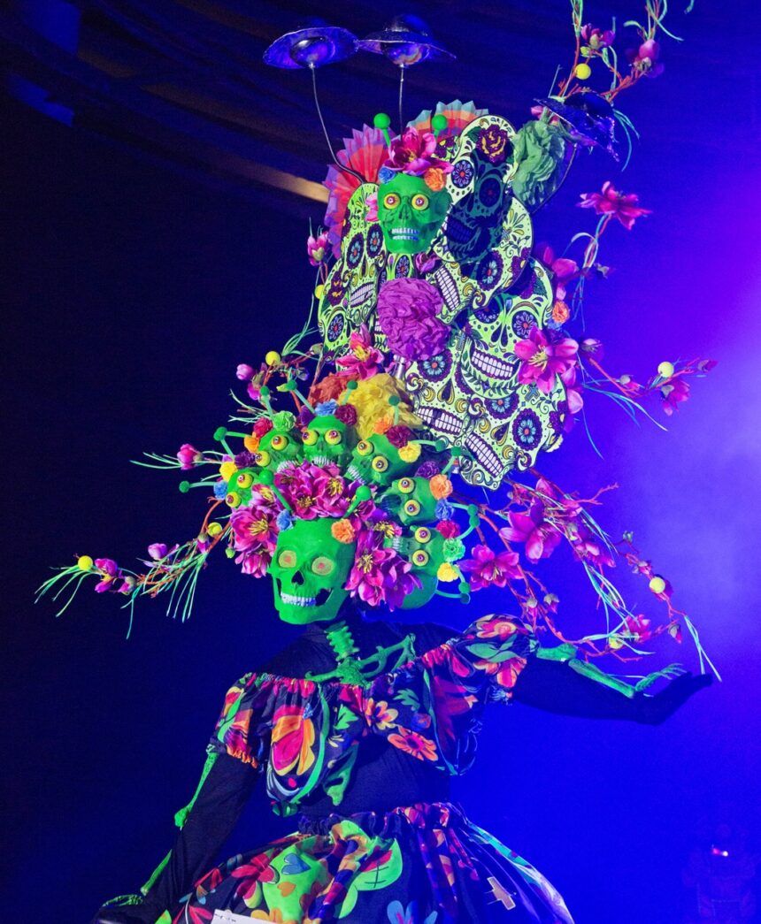 a woman in a colorful dress with flowers on her head