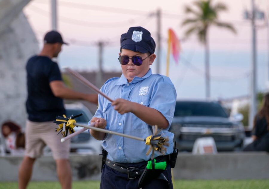 a man in a blue shirt is holding a stick