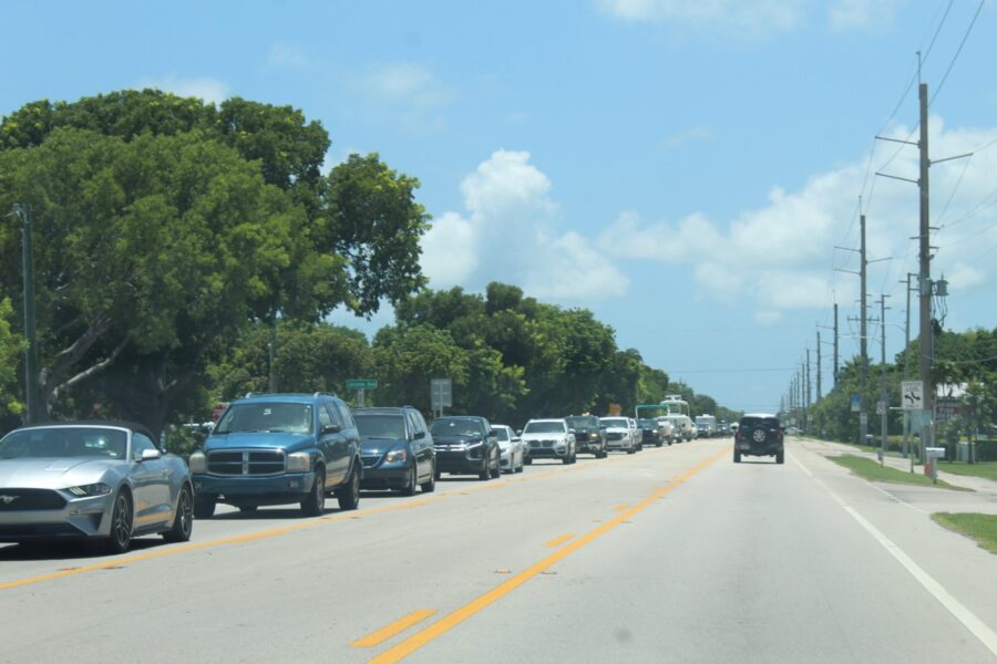 a street filled with lots of cars driving down it