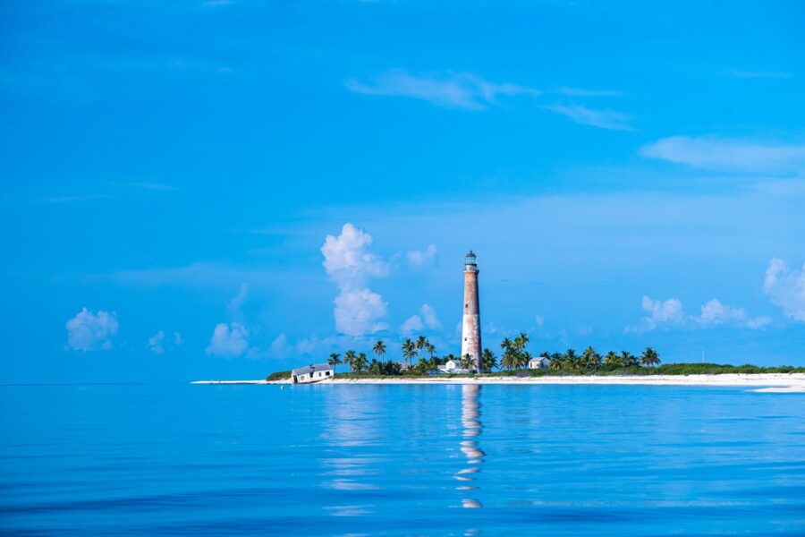 a lighthouse on an island in the middle of the ocean