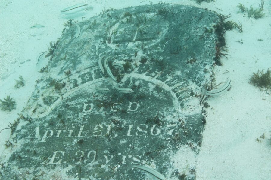 a grave in the sand with writing on it