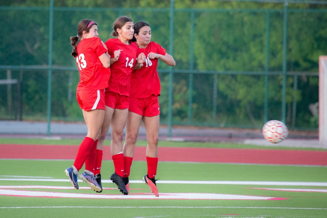 a group of young women playing a game of soccer