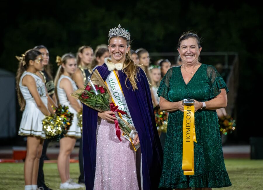 a couple of women standing next to each other on a field