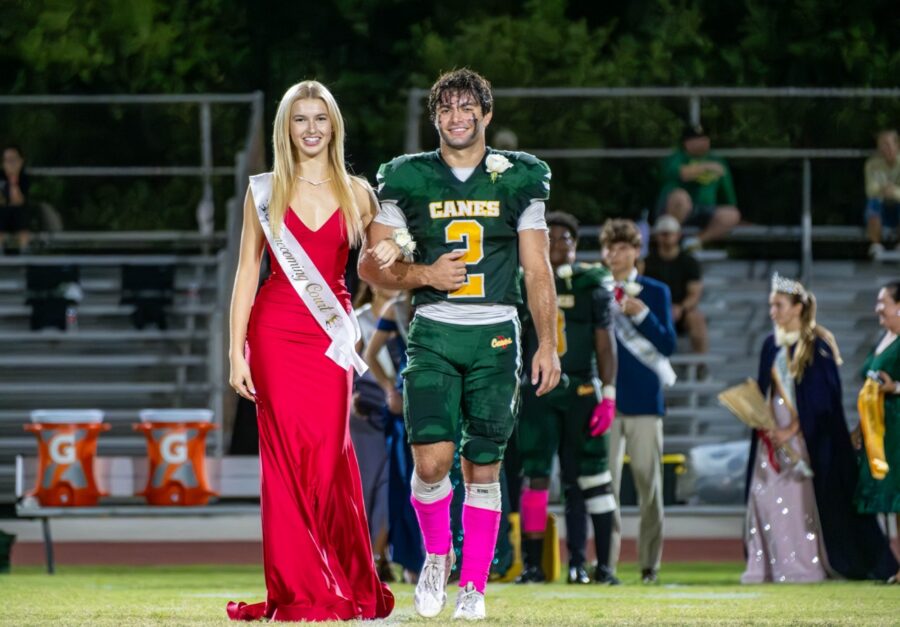 a couple of people that are walking on a field