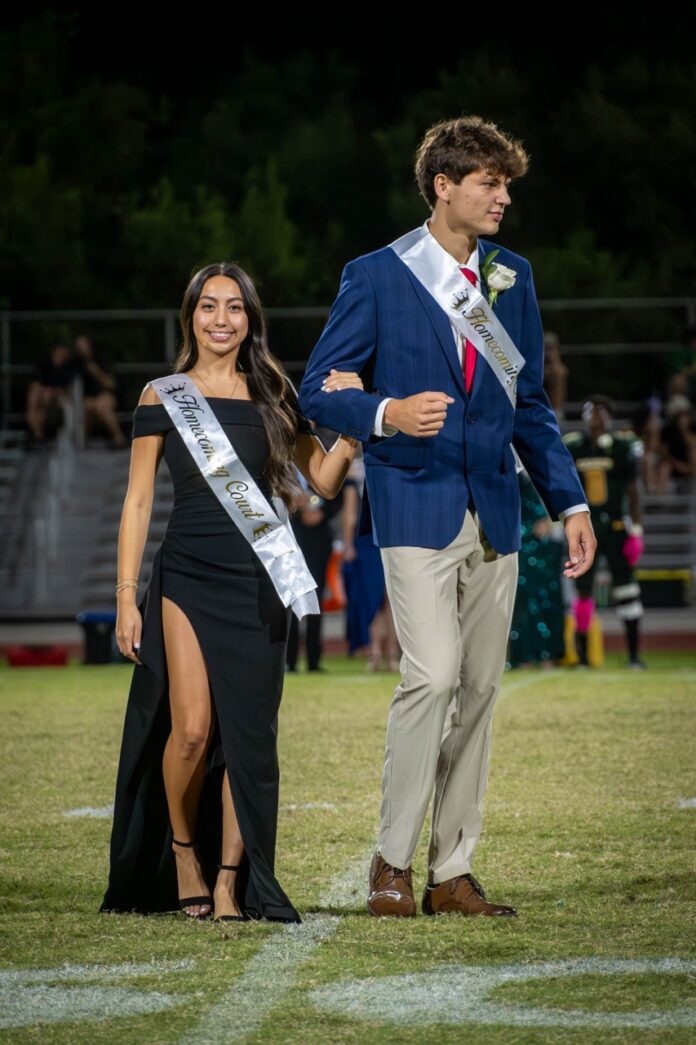 a man in a blue jacket and a woman in a black dress