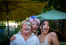 a group of women with face paint posing for a picture