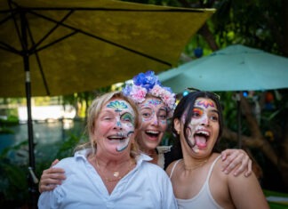 a group of women with face paint posing for a picture