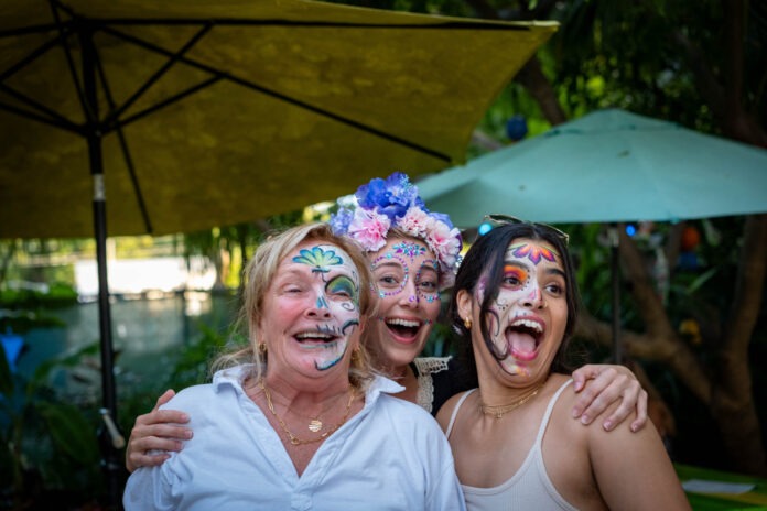 a group of women with face paint posing for a picture