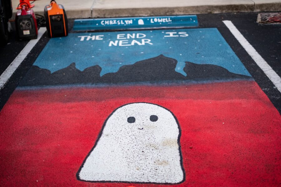 a chalk drawing of a ghost on a sidewalk