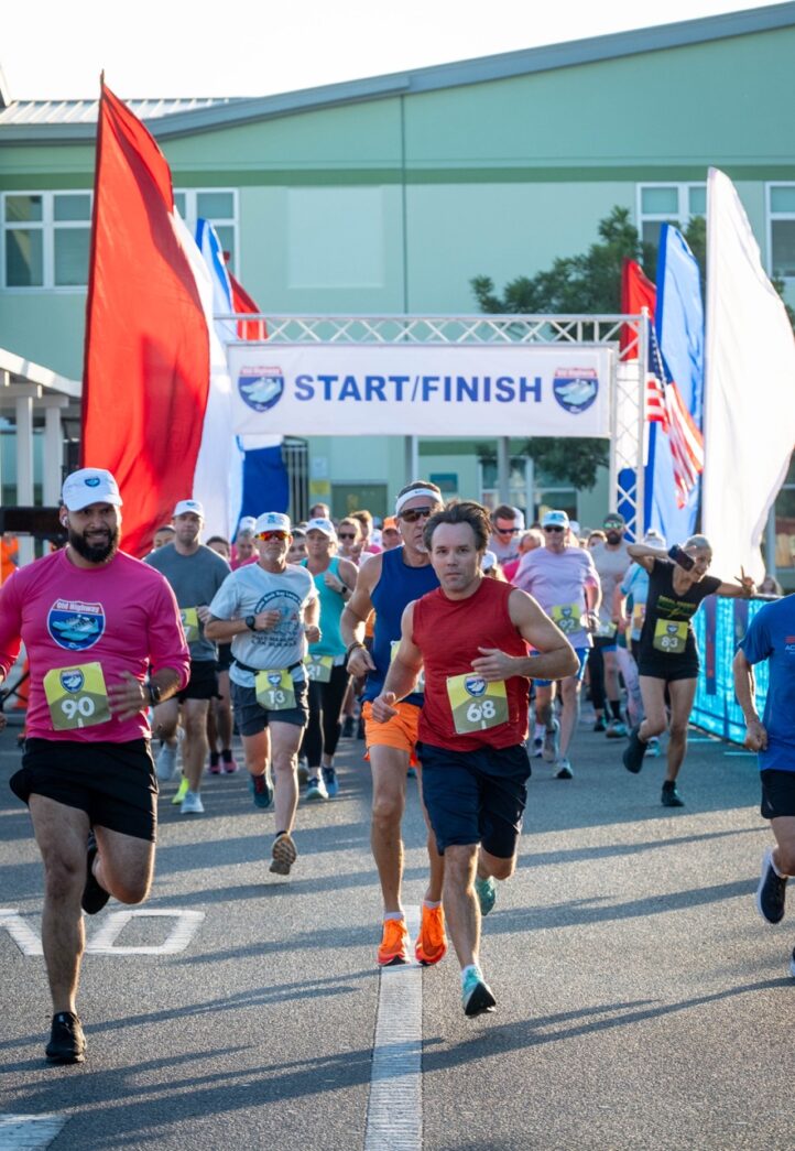 a group of people running down a street