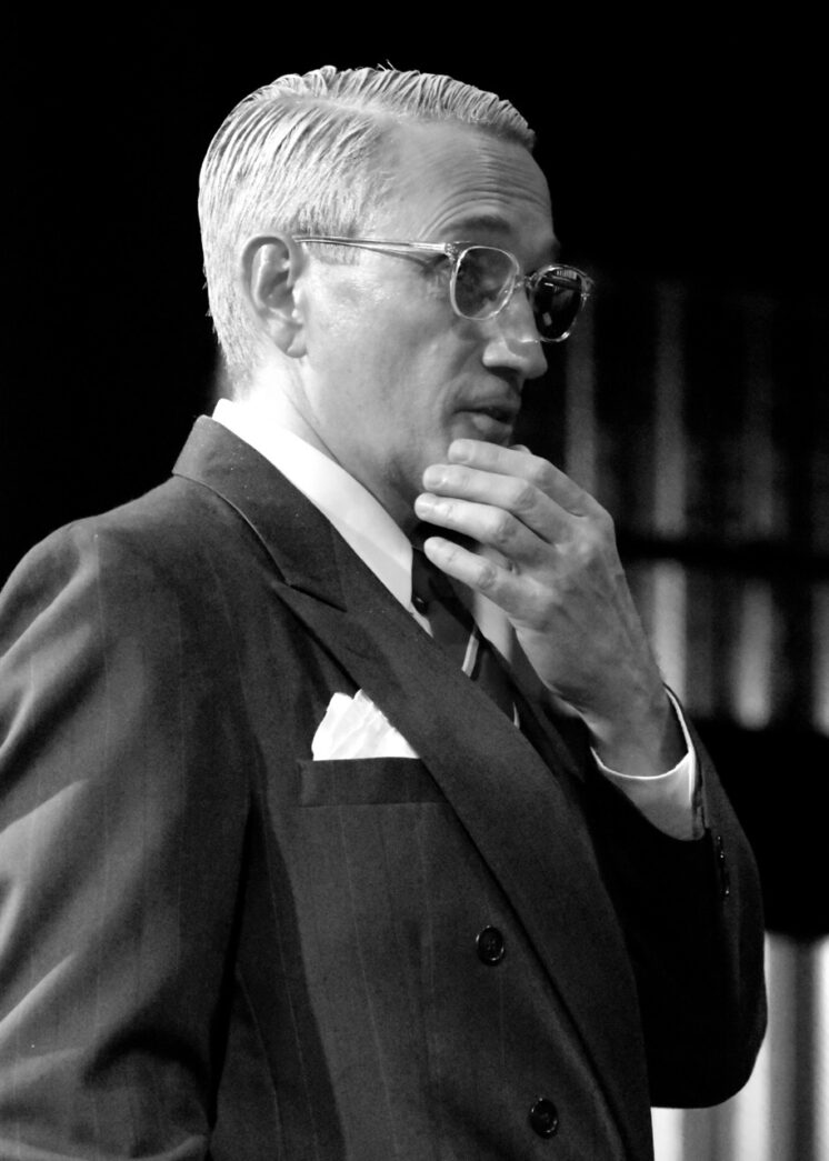 a black and white photo of a man in a suit