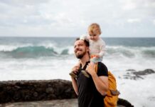 A joyful father and child enjoying time together by the ocean, capturing precious bonding moments.