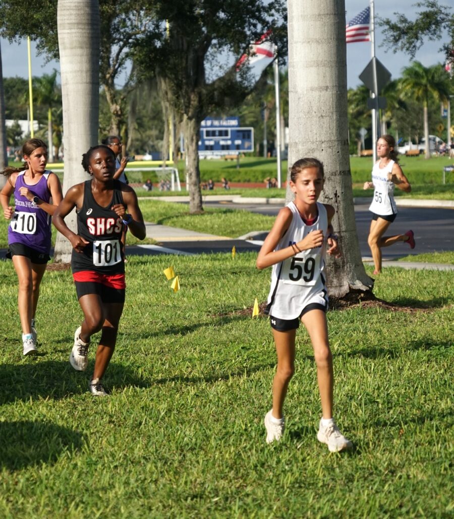 a group of girls running in a race